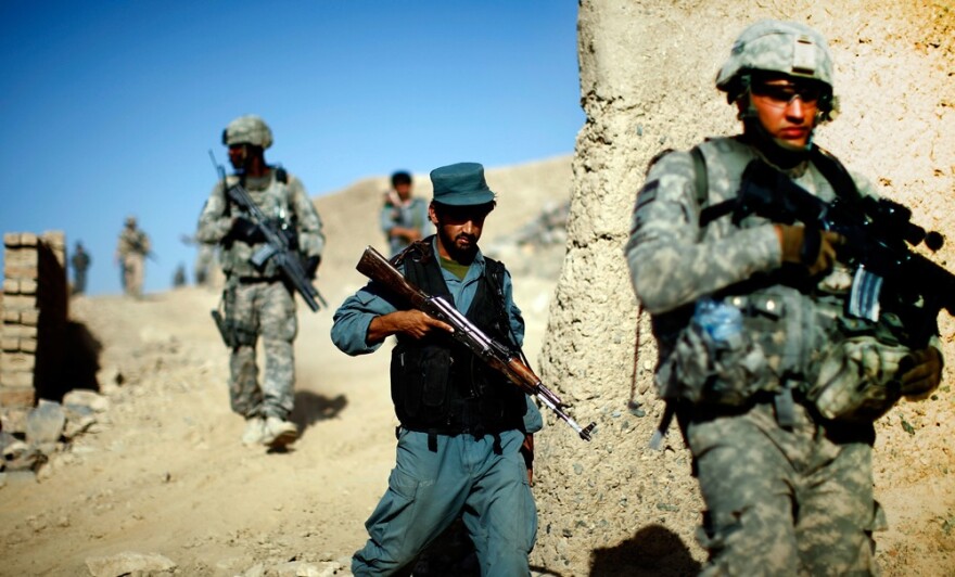 Afghan national police and U.S. soldiers on a joint patrol in a neighborhood on the outskirts of Kandahar city. The U.S. strategy in Afghanistan depends on training and equipping the Afghan security forces, making them self-reliant and allowing U.S. troops to withdraw.