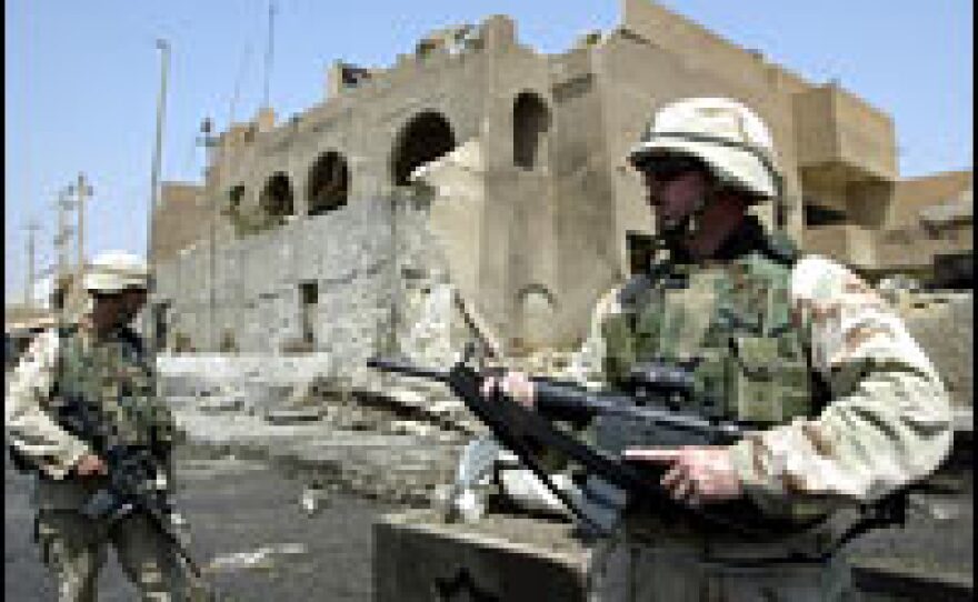 U.S. soldiers guard the Jordanian Embassy in Baghdad, where a car bomb exploded, killing several people, Aug. 7, 2003.