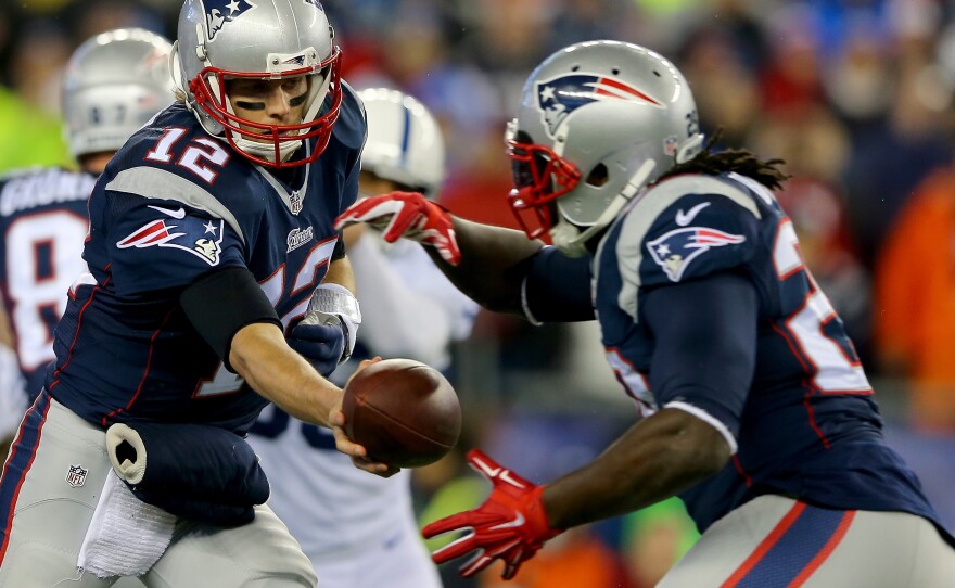 Tom Brady of the New England Patriots hands the ball off to LeGarrette Blount during the AFC Championship Game. The Patriots are being investigated because of game balls that were improperly inflated.