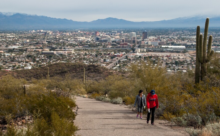 Hikers climb past saguaro cacti on Tumamoc Hill, just west of downtown Tucson. The popular hiking path is trafficked by a far more diverse group of people than neighboring Saguaro National Park.