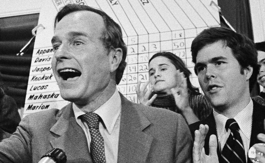 George Bush claims victory in the 1980 Iowa caucuses, with his son Jeb at his side. Jeb Bush would fail in his bid for the White House 36 years later.