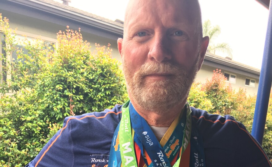 Runner Bill Aaron poses with some of the San Diego Rock 'n' Roll marathon medals he's received over the years in this undated photo.