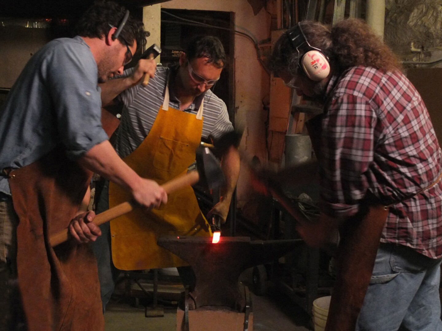 Tom Pullin (right) forges with instructor Davidé Prete and fellow veteran Jeremiah Holland (left) at the Corcoran College of Art + Design.