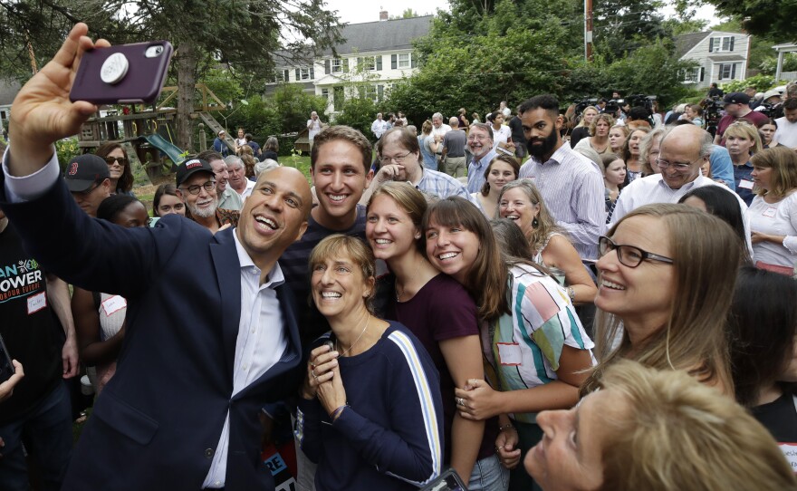 New Jersey Sen. Cory Booker takes a selfie with people at a presidential campaign event in Portsmouth, N.H.