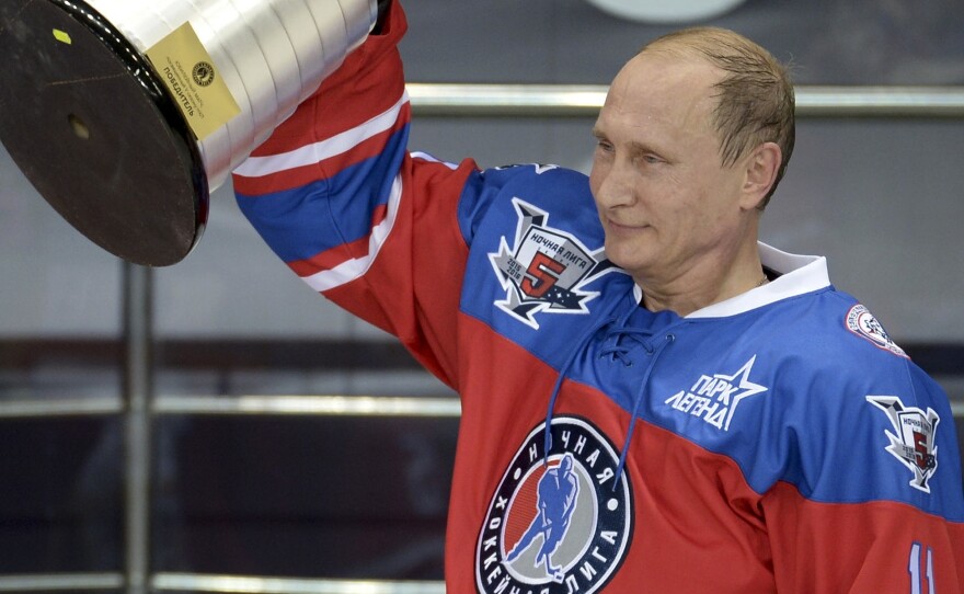 Putin holds a trophy at his birthday hockey match, during which he scored 7 goals.