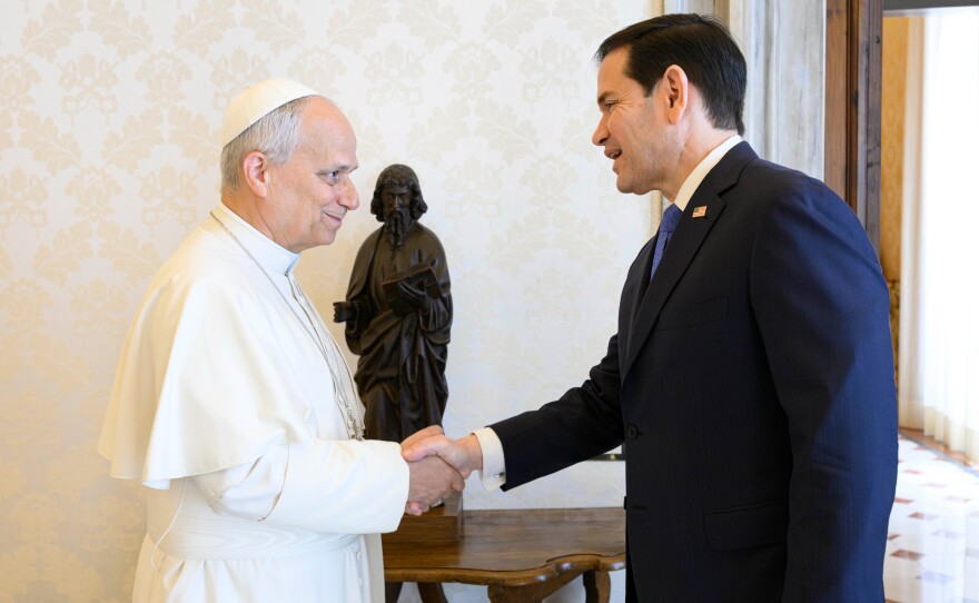 Pope Leo XIV greets U.S. Secretary of State Marco Rubio, right, upon his arrival for talks in the pope's private library at the Vatican.