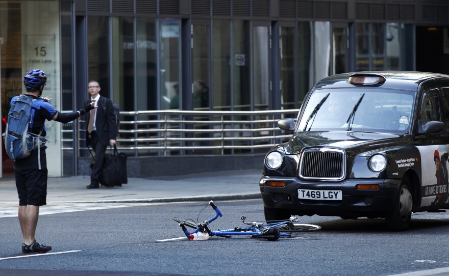 A cyclist reacts after coming off his bike in an incident with a taxi in London in 2011.