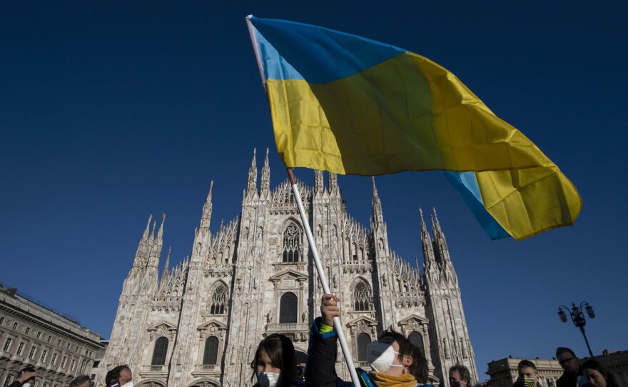 A person waves the Ukrainian flag during a demonstration against Russia's invasion of Ukraine in Milan, Italy, on Saturday.