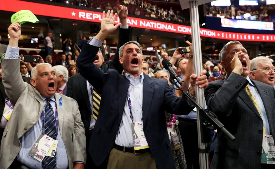 Former Virginia Attorney General Ken Cuccinelli (left) along with other delegates from Virginia chants for a roll call vote on Monday, the first day of the Republican National Convention, at the Quicken Loans Arena in Cleveland.