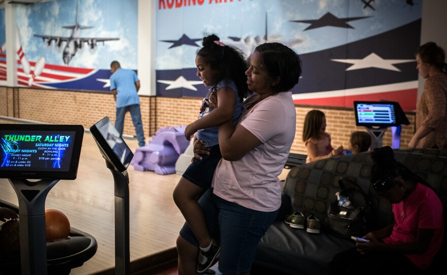 Laura Curtis and her 4-year-old daughter, Jazmin, bowl on the Air Force base. Curtis does vote, when she has time.