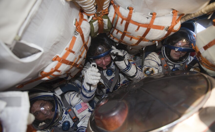 International Space Station crew members U.S. astronaut Joseph Acaba (from left) and Russian cosmonauts Gennady Padalka and Sergei Revin sit inside a Soyuz capsule shortly after landing near the town of Arkalyk in northern Kazakhstan Sept. 17, 2012.
