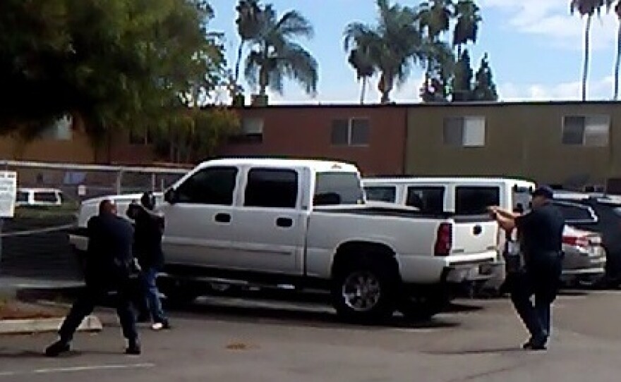 El Cajon police officers confront Alfred Olango in the parking lot of a taco shop, Sept. 27, 2016.