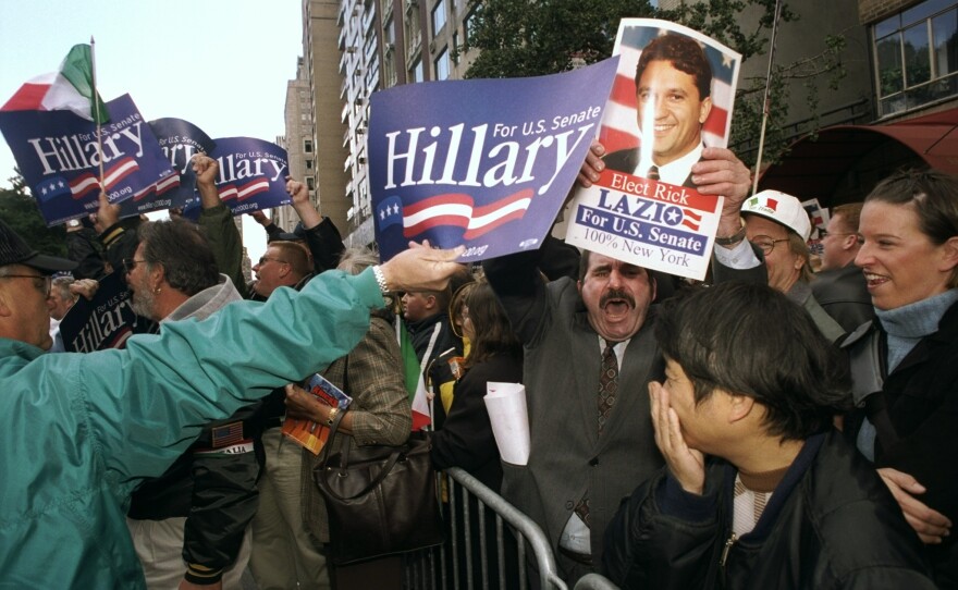 Banners and voices are raised as supporters of Senate candidates Clinton and Rick Lazio meet at 59th St. during the annual Columbus Day Parade in New York City.