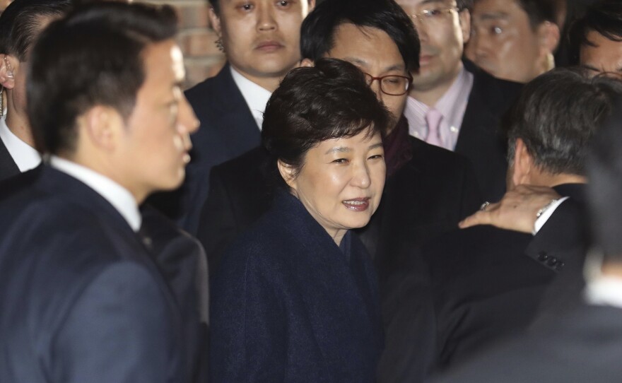 Ousted South Korea's former President Park Geun-hye, center, arrives at her private home in Seoul, South Korea, on Sunday. She vacated the presidential palace and returned to her home two days after the Constitutional Court removed her from office.