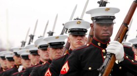 Marines in uniform standing at attention. 