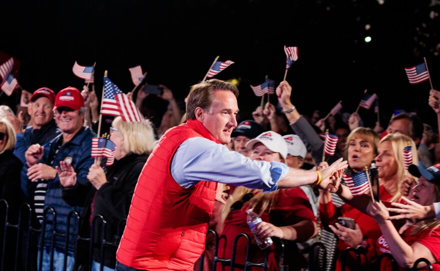 Gov. Glenn Youngkin shakes hands with supporters during a Secure Your Vote Rally on Oct. 23 in Glen Allen, Va.