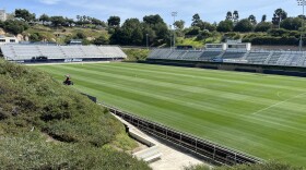A landscaper trims the grassy field in a lawn mower at University of San Diego's Torero Stadium, March 16, 2026.