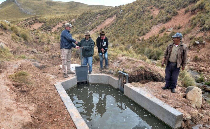 Villagers in Canchayllo stand by a reconstructed canal.