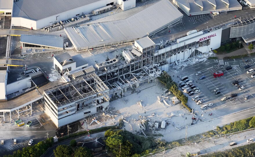 This aerial image shows the damaged AEON shopping center following an earthquake in Kashima, Kumamoto prefecture, southern Japan, Tuesday.