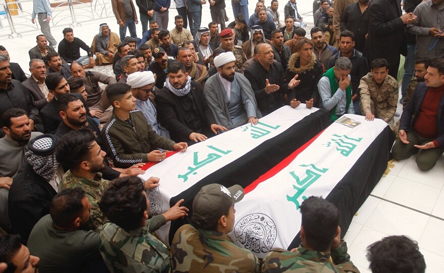 Mourners pray over the flag-draped coffins of two Popular Mobilization Forces fighters killed in the Thursday U.S. airstrike in Iraq, during their funeral procession at the Imam Ali shrine in Najaf, Iraq, Saturday.