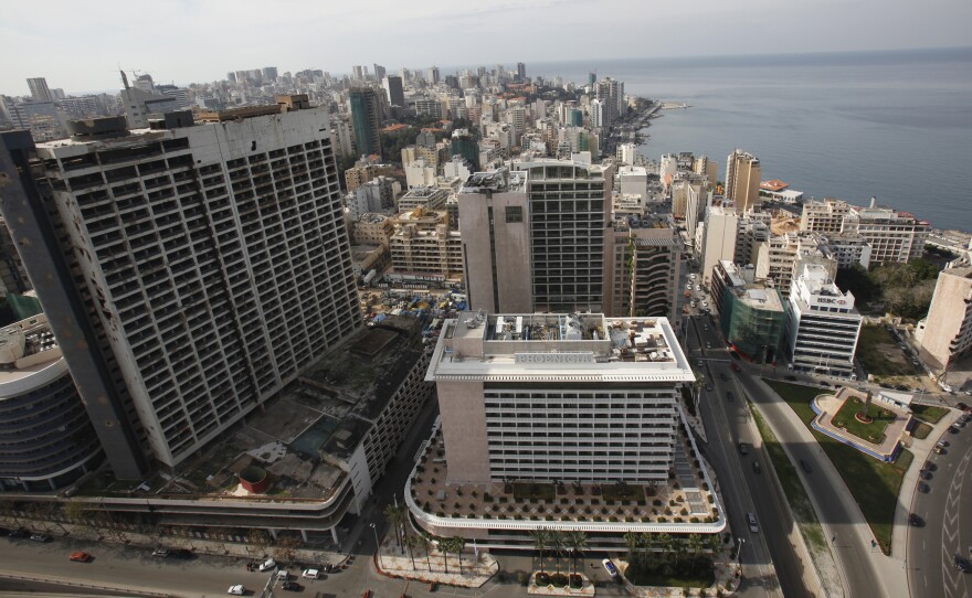 An aerial view shows the war-ravaged and deserted former Holiday Inn hotel (the tall building on the left), next to the Phoenicia hotel next in 2011.