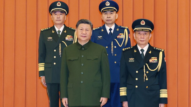 In this photo released by Xinhua News Agency, Chinese President Xi Jinping, bottom left, who is also Chairman of the Central Military Commission (CMC) poses for photos with newly promoted generals Wang Shuguang, top left and Wang Gang, top right while Zhang Shengmin, Vice Chairman of the CMC stands at the right in Beijing, on Friday, July 3, 2026.