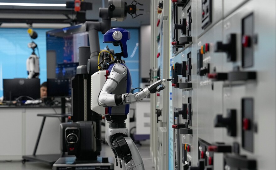 Artificial Intelligence robots demonstrate working on power grid control units during a media organized tour at Guangdong Power Grid Robotics Laboratory in Guangzhou, in southern China's Guangdong province, Thursday, April 16, 2026.