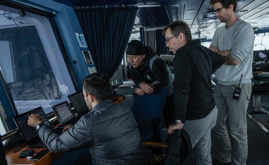 Marc de Vos, (from left) senior meteorologist/oceanographer from South African Weather Service, shows weather data to Jean-Christope Caillens, off-shore manager, Nico Vincent, expedition sub-sea manager, and Lasse Rabenstein, chief scientist, on the bridge of the S.A. Agulhas II, seen here last month during the Endurance22 expedition.