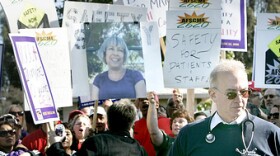 At a rally at Napa State Hospital in January, workers demand better safety measures for staff and patients. One worker carries a sign with a photo of Donna Gross, a hospital worker killed last year, allegedly by a patient.