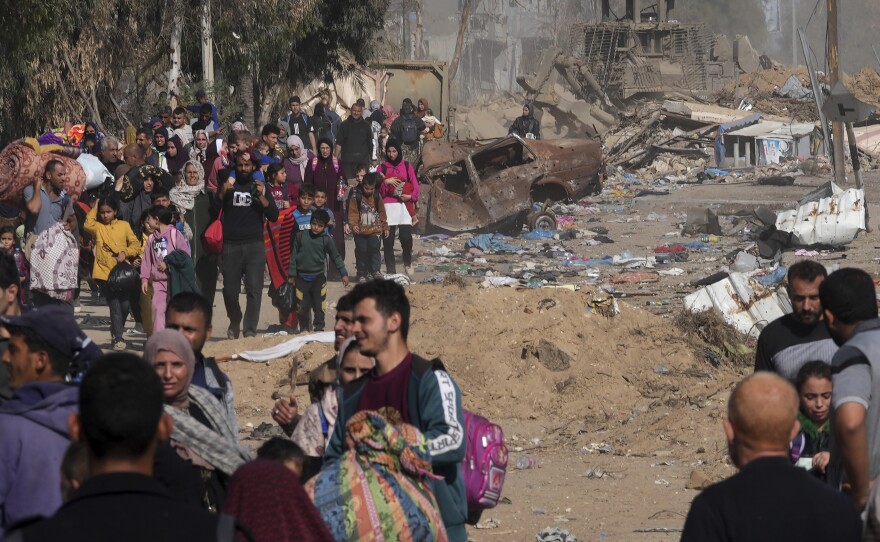 Palestinians flee to the southern Gaza Strip along Salah al-Din Street, on the outskirts of Gaza City, in front of an Israeli army bulldozer on Saturday.