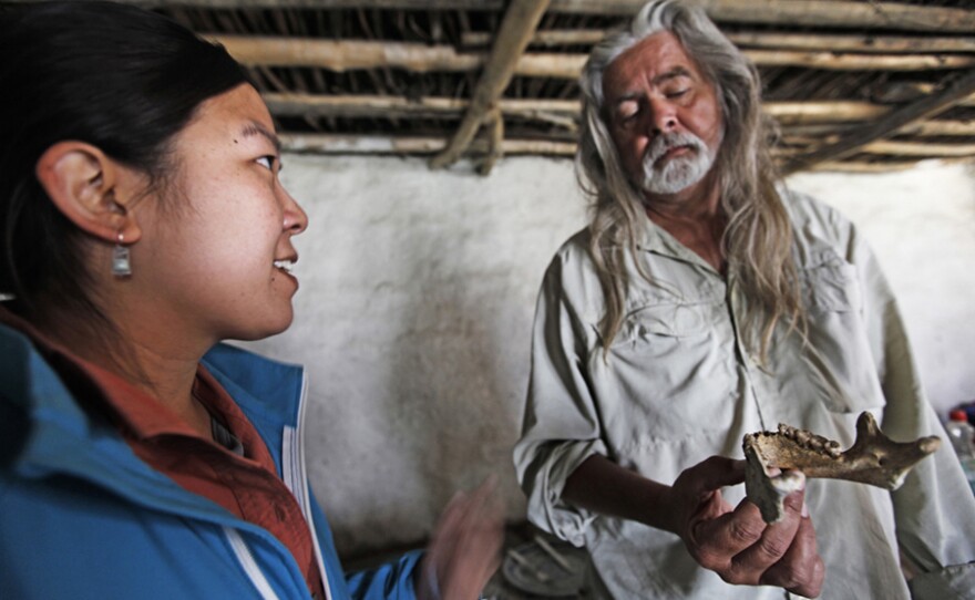 Bioarchaeologist Jacqueline Eng and lead archaeologist Mark Aldenderfer with a mandible.