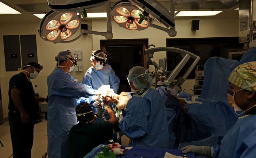 Surgeons performing a decompressive craniectomy