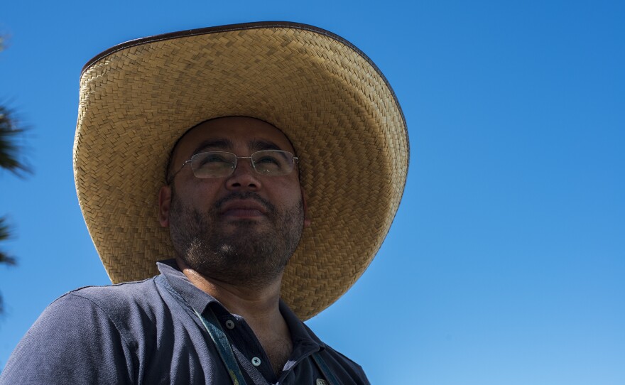 Enrique Chiu, a Tijuana-based artist, pauses for a moment while preparing to paint the fencing of the wall between the U.S. and Mexico at Friendship Park in Tijuana on Oct. 7, 2017. Chiu is a U.S.-trained artist and has dedicated nearly a year to painting murals on the southern side of the border wall.