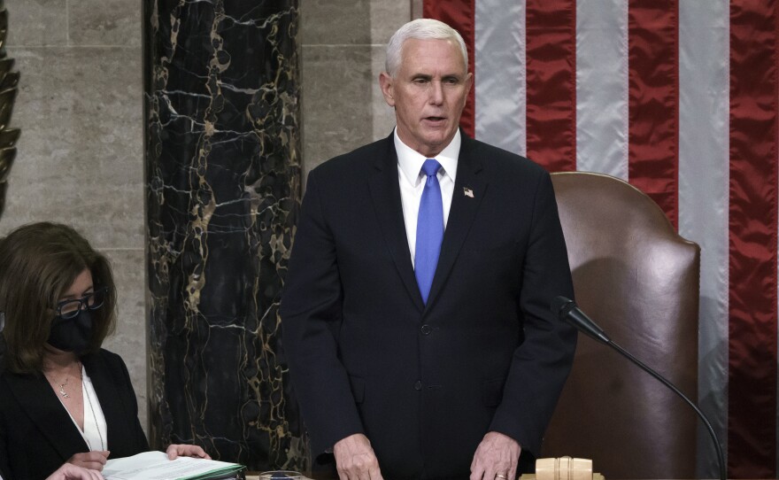 Hours after rioters stormed the Capitol, Vice President Mike Pence listens after reading the final certification of Electoral College votes cast in November's presidential election.
