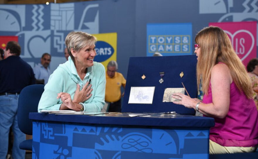 Leila Dunbar (right) appraises an early 1900s automotive racing archive in Cleveland, Ohio.