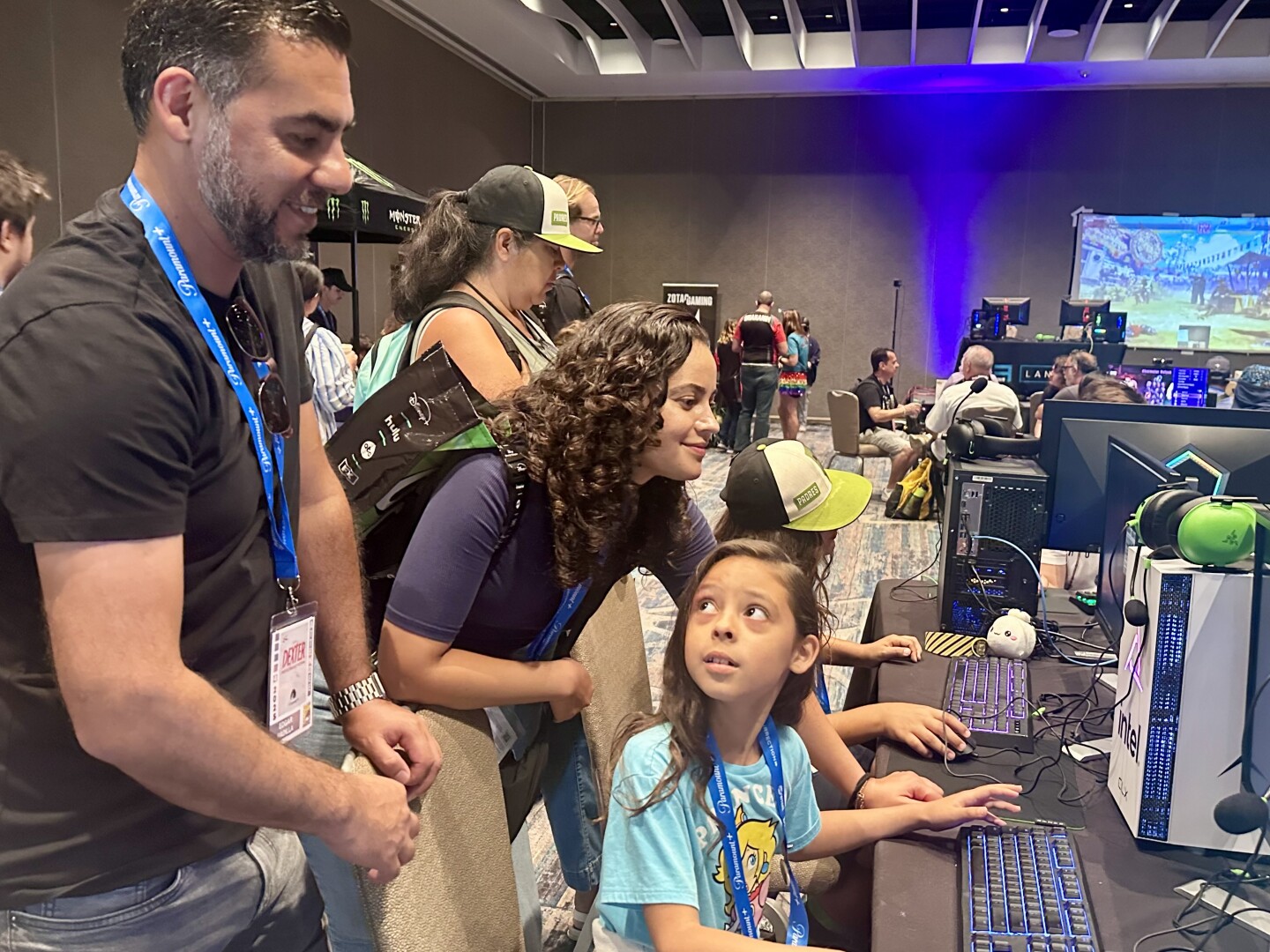 Young Minecraft fan Denise Padilla, from Tijuana, briefly looked up at her dad while playing in the Comic-Con game room. She and her parents, Denise and Edgar, attended Comic-Con for the first time on Sunday, July 27, 2025