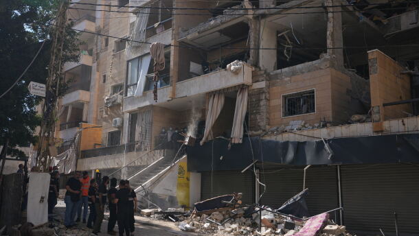 Lebanese security officers gather at the site where an Israeli airstrike hit a building in Dahiyeh, Beirut's southern suburb, Lebanon, Sunday, June 7, 2026.