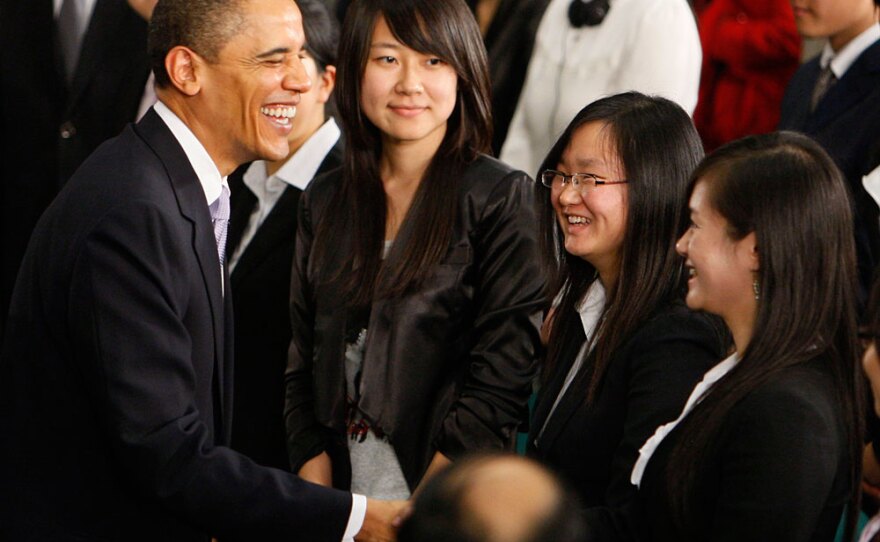 President Obama talks to the audience after a town hall meeting at the Museum of Science and Technology in Shanghai.
