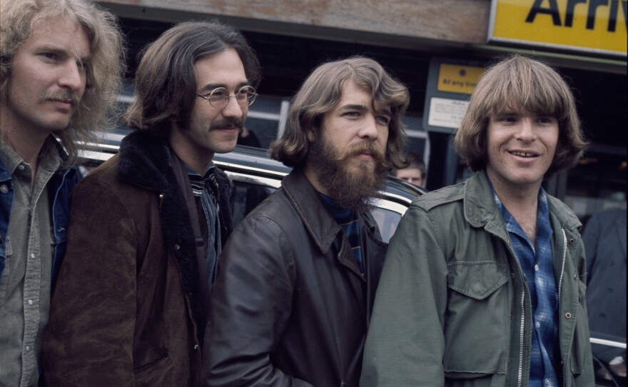 The original lineup of Creedence Clearwater Revival, at London's Heathrow Airport. L-R: Tom Fogerty, Stu Cook, Doug Clifford, John Fogerty.