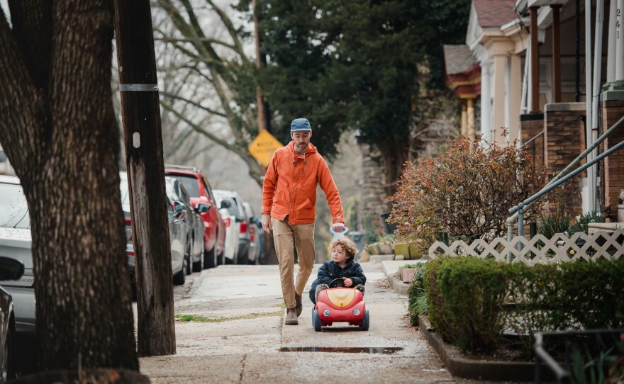 Malachy Egan plays with his son Malachy, 3, on their street in Philadelphia on March 19. Egan is a writer and illustrator and has been working at home with his children since mid-March. The family is trying to take time for moments of joy, like making art or celebrating a half birthday.