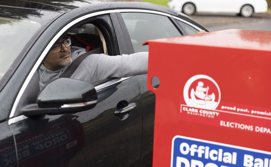 In this file photo, a voter drops his ballot in a ballot drop box in Vancouver, Wash., on Nov. 5, 2024.