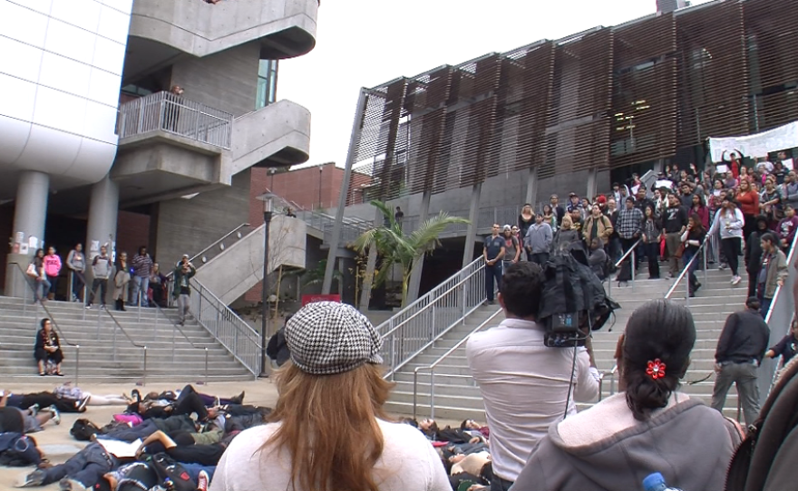 City College students lie on the ground and observe a moment of silence in honor of slain Missouri teen Michael Brown, Dec. 2, 2014.