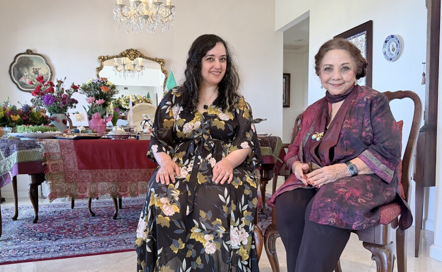 Susie Ghahremani (at left) and her mother, Zohreh Ghahremani, are shown in front of Zohreh's Nowruz spread and haft-seen on March 17, 2026. The two recently collaborated on the children's book "Celebrate Nowruz."
