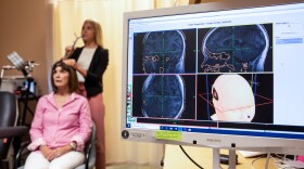 Eleanor Cole, Ph.D., demonstrates the treatment on trial participant Deirdre Lehman in May 2019 at the Stanford Brain Stimulation Lab.