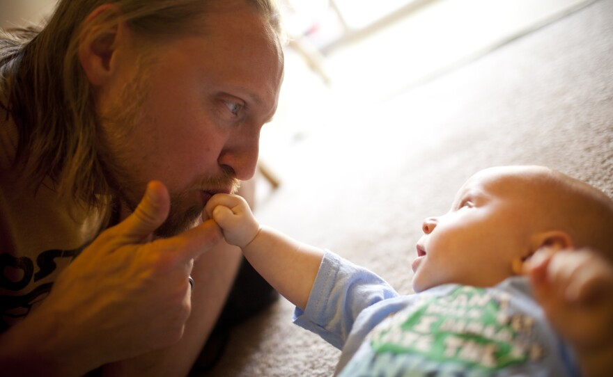 Jonathan Heisey-Grove kisses his 4-month-old son, Zane, in their home in Alexandria, Va. Jonathan is part of a growing number of fathers who stay at home full time while their wives financially support the family.