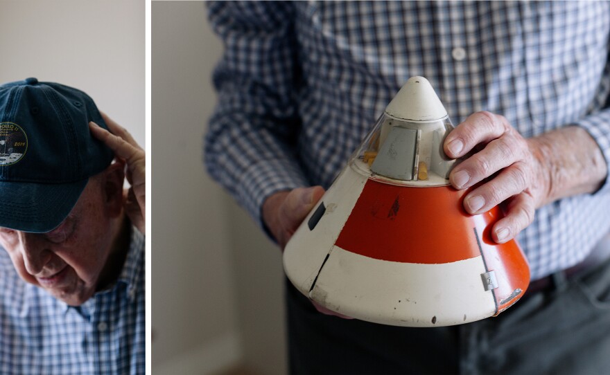 Chuck Lowry keeps Apollo memorabilia, both old and new, in his home. (Left) Lowry adjusts a cap commemorating the 50th anniversary of Apollo 11. (Right) Lowry holds a model of a prototype command module.