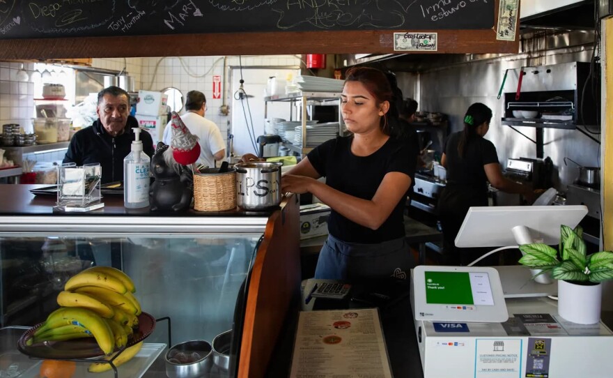 Waitress Daisy Marlene Montes Carranza works at El Rincon restaurant in the San Ysidro neighborhood of San Diego on April 16, 2024. Some economists say workers like Carranza may not get much benefit from the 'no tax on tips' change to the tax code. 