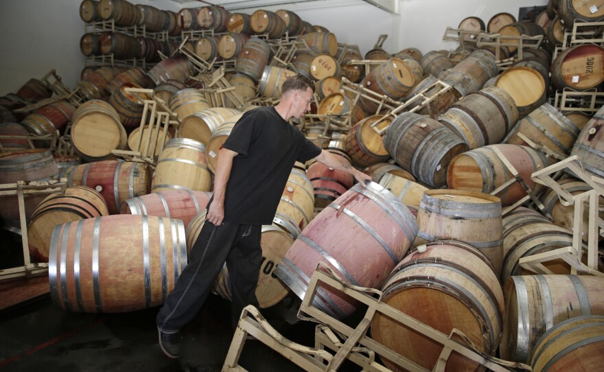 Cellar worker Daniel Nelson looks over toppled barrels of Cabernet Sauvignon following an earthquake at the B.R. Cohn Winery barrel storage facility in Napa, Aug. 24, 2014.