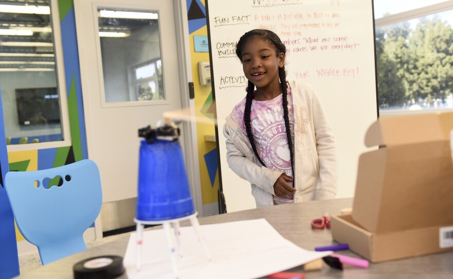 Damya E. checks out the new robot she built at the Watts/Willowbrook Boys & Girls Club's new Disney STEM Center of Innovation on Friday, June 7, 2019 in Los Angeles. 