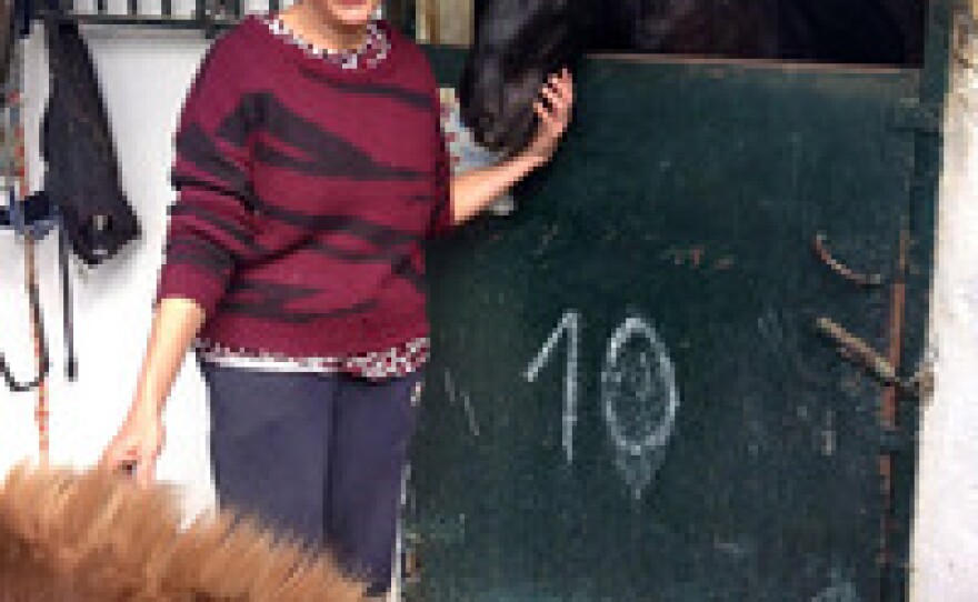 Concordia Márquez, founder of the CYD Santa Maria shelter,  poses with two horses she adopted.